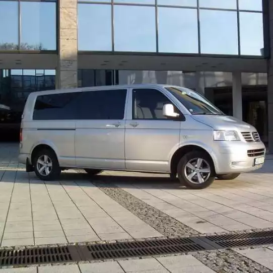 Silver van waiting for customers during an airport pick up.