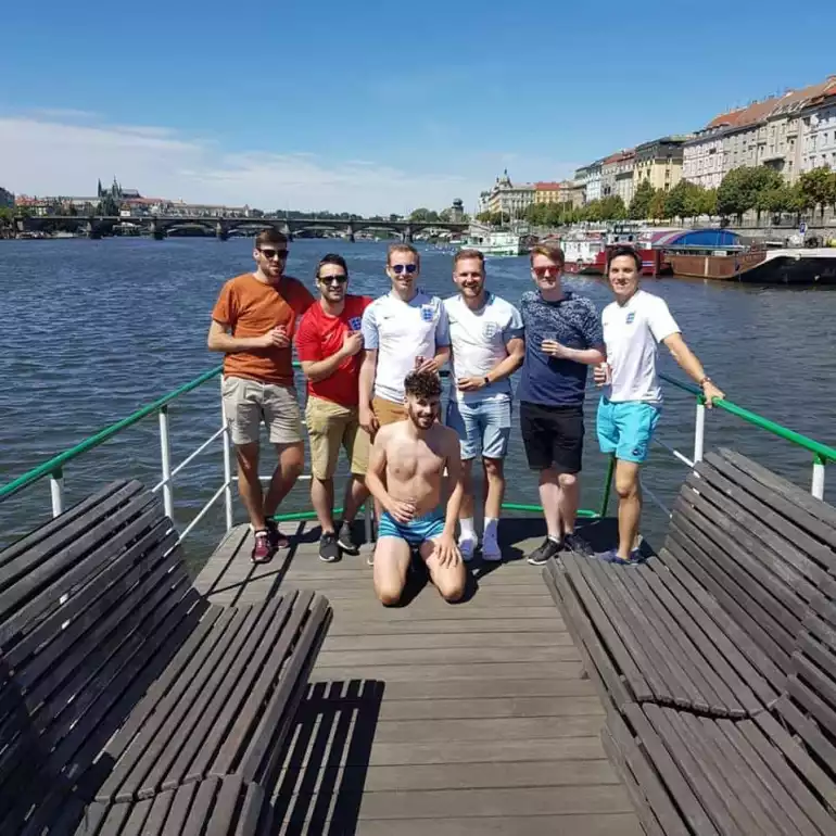 Group of people posing on a private boat during a bachelor party.