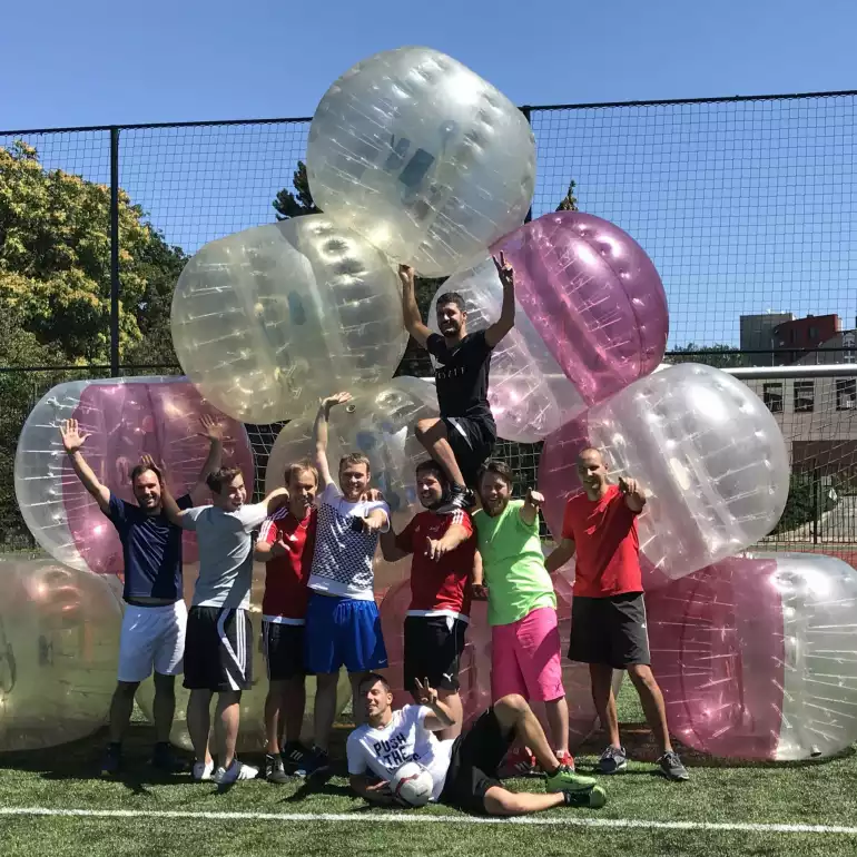 Group of people celebrating after a fun game of bubble football.