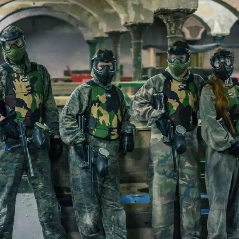 Group of paintball players in full uniforms and gear.