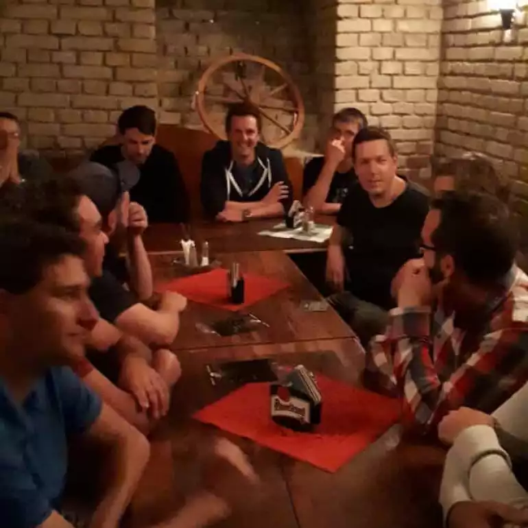 Large group of people enjoying a meal in a private room of a restaurant.