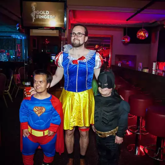 Dwarfs entertainers dressed as superman and batman with the groom to be dressed as snow-white.