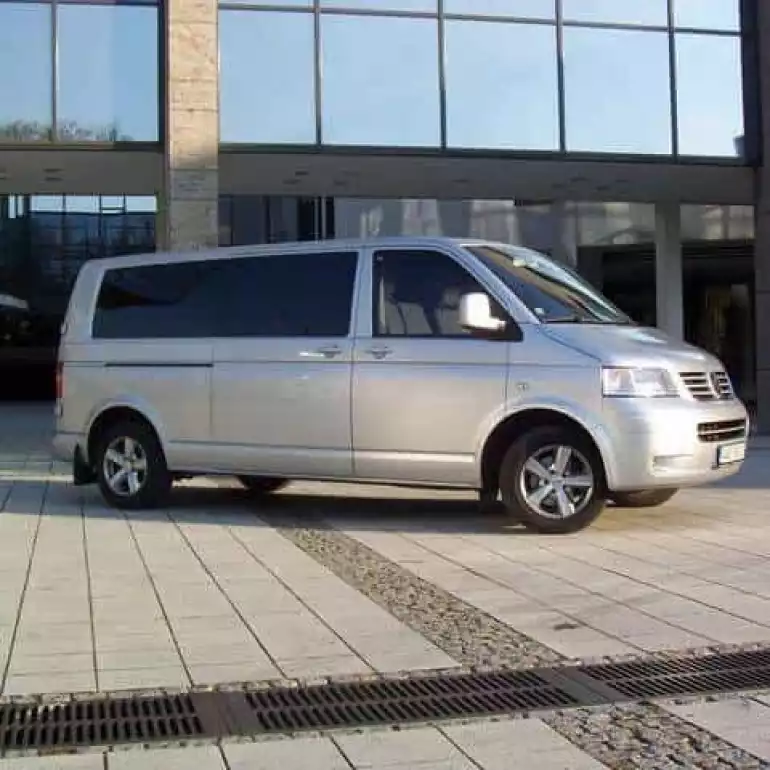 Small van waiting for passengers outside of Budapest airport waiting to complete the airport transfer.