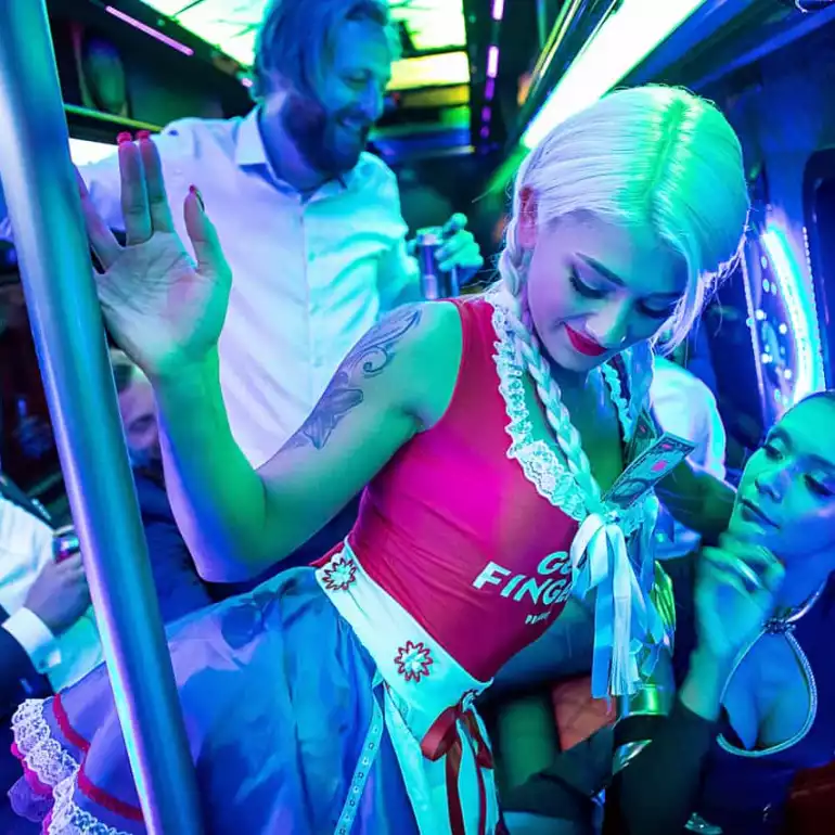 Sexy blond girl dancing with a group of guys in a VIP shuttle.